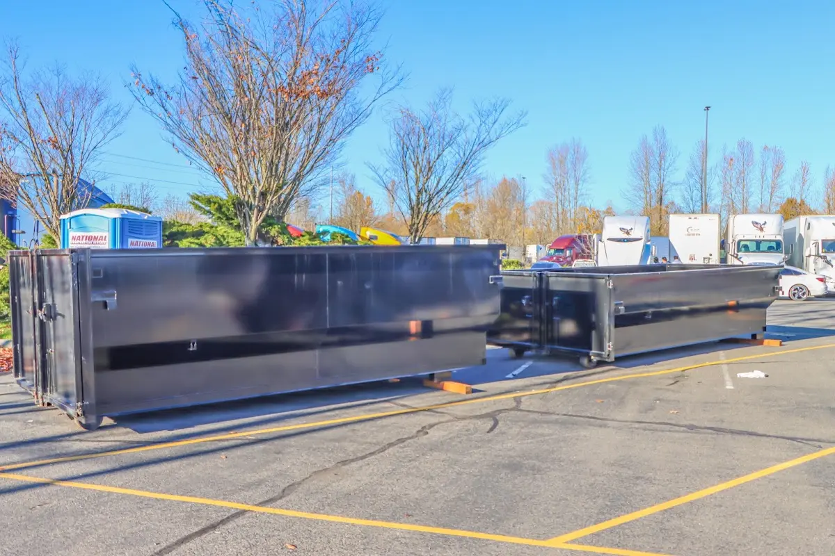 Professional dumpster rental service with roll-off container on residential driveway in Norwich